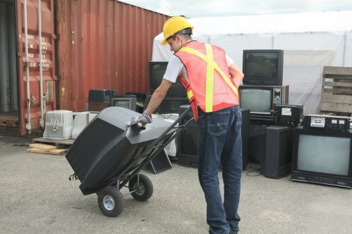 Collection van and staff loading recyclable appliances for refurbishment