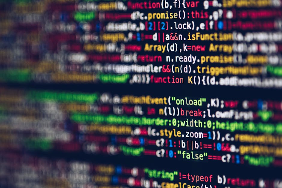 A photograph of a smartphone or computer screen displaying lines of HTML code, including tags such as <head>, <body>, and <link>, with syntax highlighting featuring blue, red, and wh